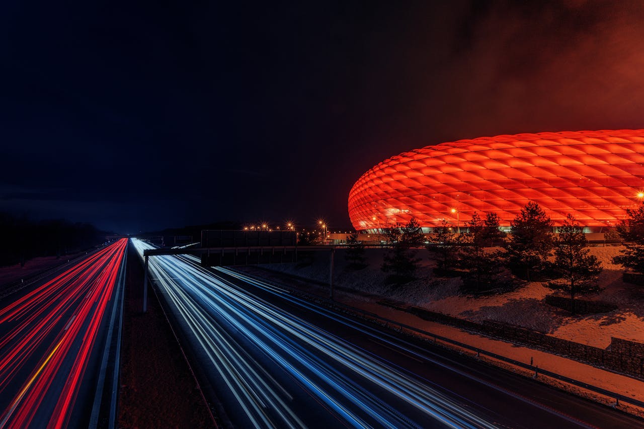 The Art of Drawing Readers In: Your attractive post title goes here Capture of Allianz Arena illuminated at night with dynamic light trails.